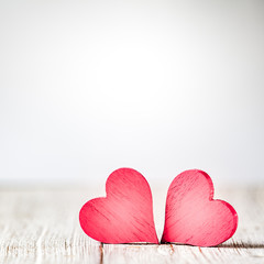 Wall Mural - two red hearts on wooden background