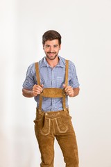 Wall Mural - Junger Mann in Lederhosen lächelt