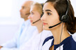 © rogerphoto - Call center. Focus on beautiful woman in headset