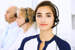 © rogerphoto - Call center. Focus on beautiful woman in headset