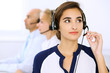 © rogerphoto - Call center. Focus on beautiful woman in headset