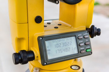 Closeup theodolite outdoors at construction road  Selective focus.