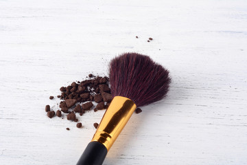 Make up brush with brown powder.