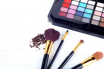 Make up brushes with eye shadows palette.