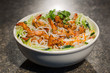 Rice vermicelli with fried shrimps and salad of lettuce, herbs a