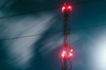 communication antenna tower. radio antenna tower. cell tower with red lights.