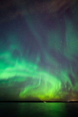Wall Mural - northern lights over lake in finland