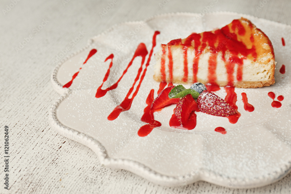 Delicious piece of cheesecake with berries on white plate