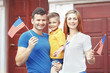 © Africa Studio - Happy family with little  American flags beside home door