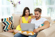 © Africa Studio - Beautiful young couple using laptop at home