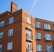 Block of council flats in red bricks and white windows