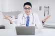 © Creativa Images - Male doctor with notebook in the clinic