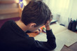 © sakkmesterke - Sad schoolboy doing homework