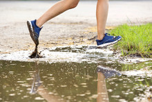 Female Runner Legs Running In Mud