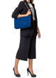 © fotofabrika - Woman holding a handbag isolated on white background