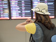 © npstockphoto - Single woman checking flight at airport 1