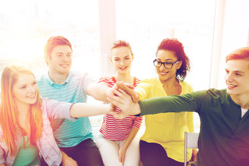 Sticker - smiling students making high five gesture sitting