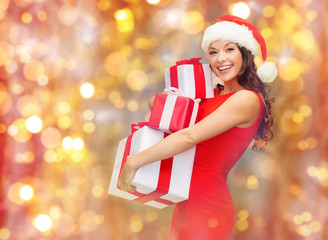 Sticker - smiling woman in santa hat holding gift boxes