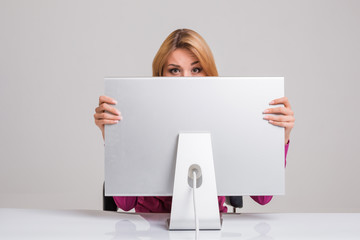 young woman sitting in the table and using computer