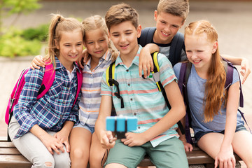 Canvas Print - happy elementary school students taking selfie