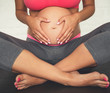 © georgerudy - Pregnant woman doing yoga