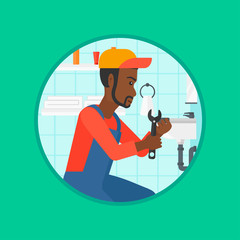 Wall Mural - Plumber fixing sink pipe with wrench.