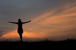 © stcom - silhouette of woman  enjoys outdoor at sunset