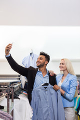 Wall Mural - Young Couple Taking Selfie Photo Fashion Shop, Happy Smiling Man And Woman Shopping Customers