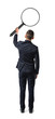 © gearstd - Back view of a businessman holding big magnifying glass in his outstretched arm isolated on white background