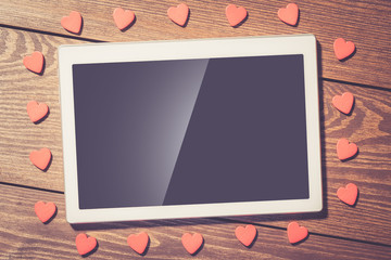 Poster - Red hearts and white digital tablet with blank screen on an old wooden table