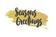 Seasons greetings message on a gold sparkling glitter background