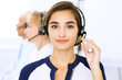 © rogerphoto - Call center. Focus on beautiful woman in headset