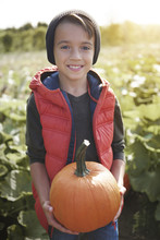 Portrait Of Little Boy With Pumpkin
