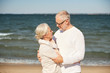© Syda Productions - happy senior couple hugging on summer beach