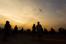 People Taking Pictures On A Airshow At Sunset