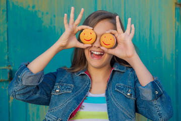 Cookies in the form of smiley. Teen girl eating cookies, snack for schoolchildren. Cheerful teen girl with cookies. people, happy childhood, food, sweets and bakery concept