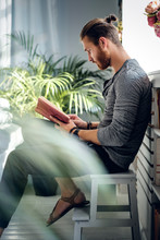 A Man Reading A Book.