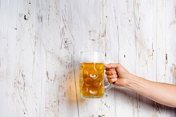 Wall Mural - Unrecognizable man holding a beer mug, studio shot