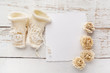 New Born or baptism Greeting Card. Blank with baby girl shoes and gloves on white wooden background
