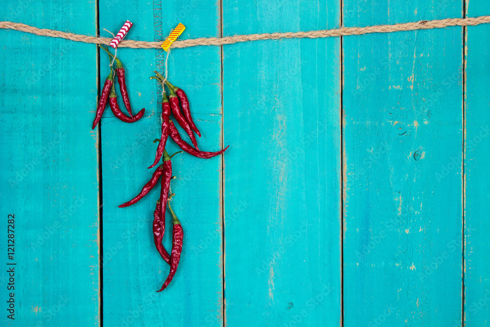 Red hot chili peppers hanging from rope Stock Photo | Adobe Stock