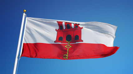 Gibraltar flag waving against clean blue sky, close up, isolated with clipping path mask alpha channel transparency