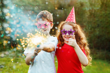 Happy children with party popper with confetti. Creative invitat