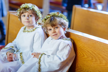 Wall Mural - Two little boys playing an angel of Christmas story in church