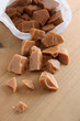 Old fashioned toffee or caramel pieces in a paper bag