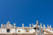 Statue of Saint Peter, St. Peter's Basilica and statues standing on the roof of St. Peter's Basilica on the background, Vatican. Italy