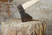 Old Wood Chopping Axe On A Wooden Trunk Block In Barn