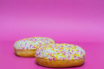 Donuts glazed on a pink background