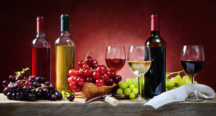 Red, rosé and white wine, with bunches of grapes