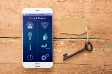 Wall Mural - Smartphone with smart home app on the wooden desk