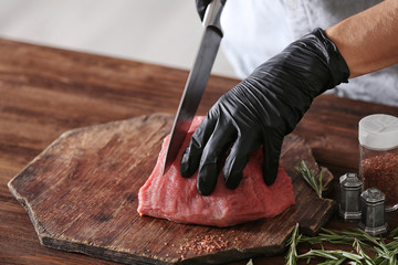 Sticker - Butcher cutting pork meat on kitchen